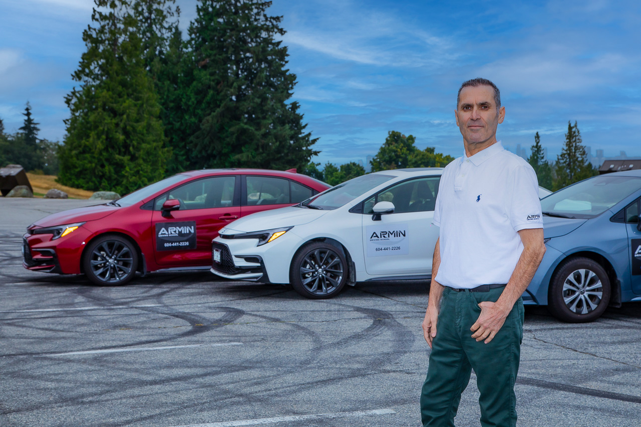 Armin Driving School instructor with training vehicles in Burnaby, BC